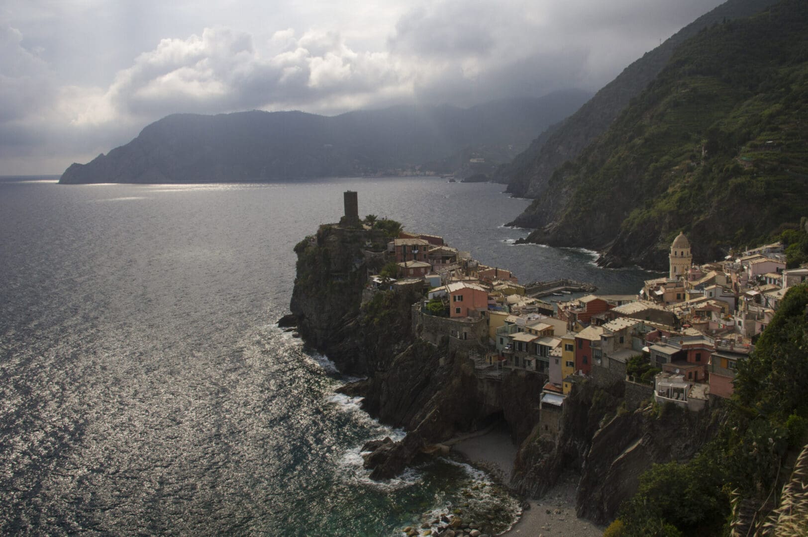 A village on a cliff overlooking the ocean.