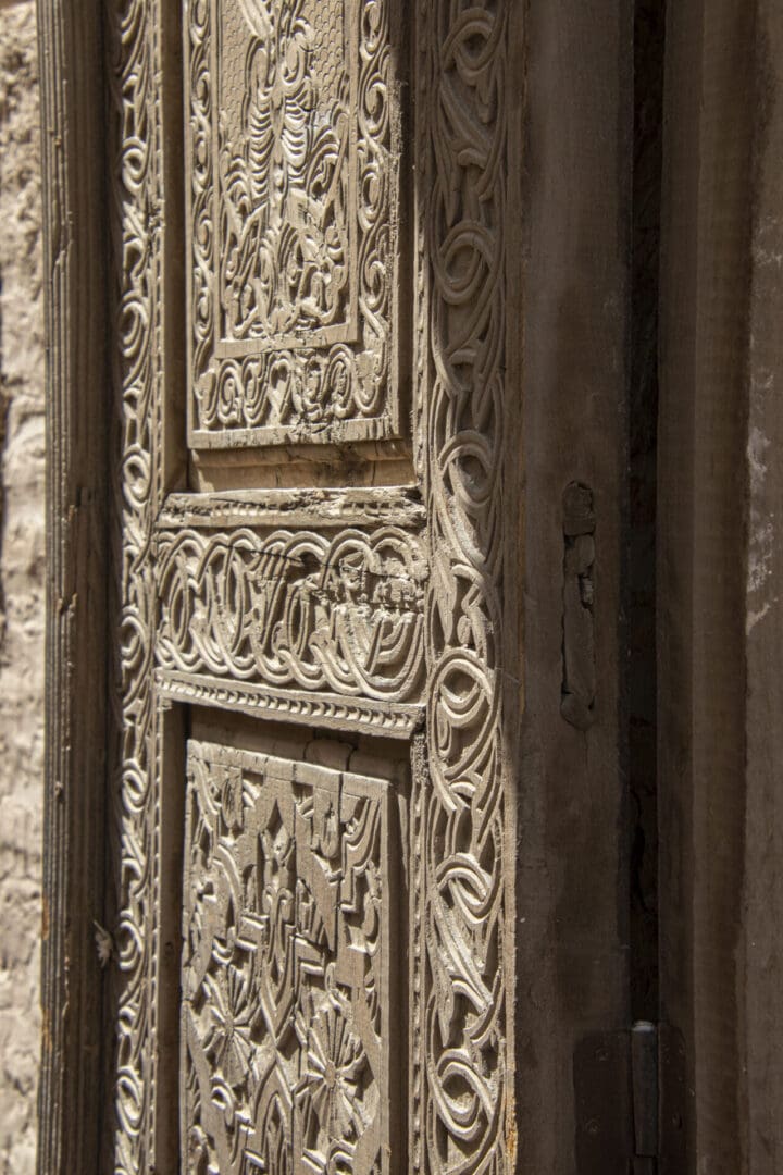 An ornate door with carvings on it.