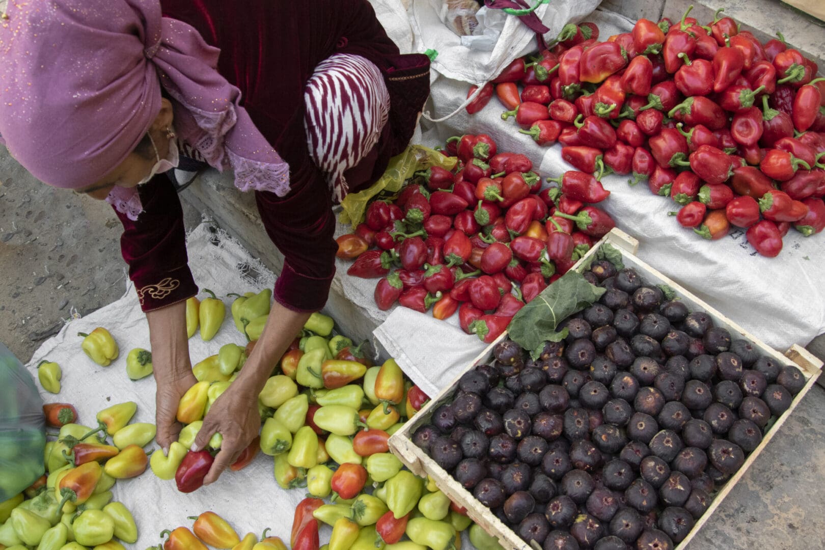 A woman is selling fruit at a market.