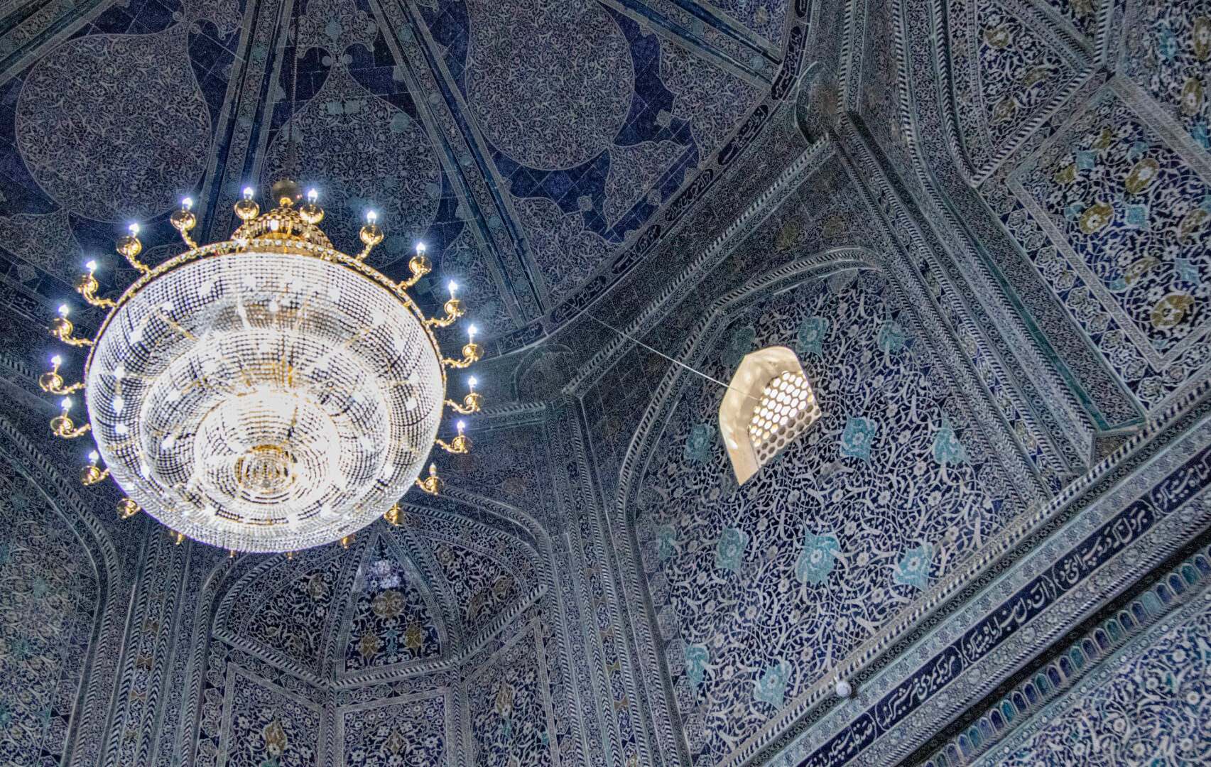 The ceiling of a blue and white building with a chandelier.